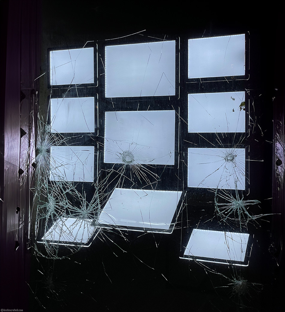 Broken window of empty real estate ads